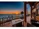 Waterfront balcony with comfortable seating and amazing sunset views over the ocean at 806 Columbus Dr, Tierra Verde, FL 33715