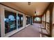 This balcony offers an intriguing view of a reflective pool, captured through large sliding glass doors framed by classic archways at 806 Columbus Dr, Tierra Verde, FL 33715