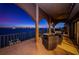 This balcony offers captivating evening views of the illuminated coastline, enhancing its allure with outdoor seating and open space at 806 Columbus Dr, Tierra Verde, FL 33715