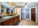 Bathroom features double vanity, granite countertop, and a glass block shower at 806 Columbus Dr, Tierra Verde, FL 33715
