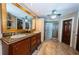 Elegant bathroom with double vanity, a large glass shower, and marble flooring at 806 Columbus Dr, Tierra Verde, FL 33715