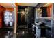 This bathroom features dark granite tiling and an elaborate granite sink and shower unit, lending it a dark, opulent feel at 806 Columbus Dr, Tierra Verde, FL 33715
