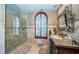 Serene bathroom with walk-in shower, mosaic accents, a custom vanity, and a decorative mirror at 806 Columbus Dr, Tierra Verde, FL 33715