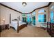 Main bedroom with stunning water views and a large four poster bed at 806 Columbus Dr, Tierra Verde, FL 33715