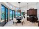 Elegant dining room with water views, modern lighting, and a built-in desk at 806 Columbus Dr, Tierra Verde, FL 33715