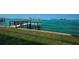 Private wooden dock and grassy backyard by the sea at 806 Columbus Dr, Tierra Verde, FL 33715