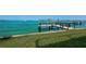 Private wooden dock and grassy backyard by the sea at 806 Columbus Dr, Tierra Verde, FL 33715