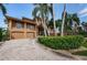 Two-story home with double garage and lush landscaping at 806 Columbus Dr, Tierra Verde, FL 33715