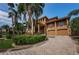 Mediterranean style home with palm trees and large driveway at 806 Columbus Dr, Tierra Verde, FL 33715