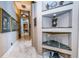 Elegant hallway with marble floors and built-in shelving at 806 Columbus Dr, Tierra Verde, FL 33715