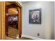 Hallway featuring a framed painting on the wall with a view into the formal living room at 806 Columbus Dr, Tierra Verde, FL 33715