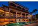 Luxury waterfront home with pool at dusk at 806 Columbus Dr, Tierra Verde, FL 33715