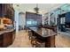 Gourmet kitchen featuring a large island, stainless steel refrigerator, and high-end finishes at 806 Columbus Dr, Tierra Verde, FL 33715