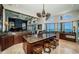 Gourmet kitchen with large center island, leather stools and views of water at 806 Columbus Dr, Tierra Verde, FL 33715