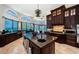 Spacious kitchen boasts dark wood cabinetry, a large center island, and gorgeous water views at 806 Columbus Dr, Tierra Verde, FL 33715