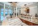 Bright living room featuring marble floors, columns, and ocean view at 806 Columbus Dr, Tierra Verde, FL 33715