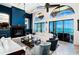 Coastal living room boasting an ocean view, dark blue accent wall, and fireplace at 806 Columbus Dr, Tierra Verde, FL 33715