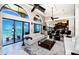 Bright living room featuring tall windows with water views, open to a modern kitchen at 806 Columbus Dr, Tierra Verde, FL 33715