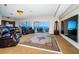 Spacious living room with beautiful ocean view, leather chairs, and a large TV at 806 Columbus Dr, Tierra Verde, FL 33715