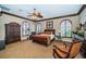 Spacious main bedroom featuring arched windows, cozy sitting area, and wooden accents at 806 Columbus Dr, Tierra Verde, FL 33715
