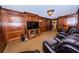Home theater with built-in wooden wall paneling and leather seating at 806 Columbus Dr, Tierra Verde, FL 33715