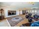 Comfortable media room with large TV, bookshelves, and leather chairs at 806 Columbus Dr, Tierra Verde, FL 33715