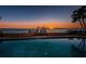 Sunset view of pool and private dock at 806 Columbus Dr, Tierra Verde, FL 33715