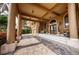 Elegant entrance featuring a porte cochere, arched doors, ample seating, and a luxurious brick driveway at 806 Columbus Dr, Tierra Verde, FL 33715