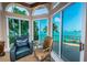 Relaxing sitting area with leather chairs and breathtaking water views at 806 Columbus Dr, Tierra Verde, FL 33715
