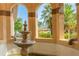 Serene fountain with arched entryway and lush tropical landscaping at 2400 Feather Sound Dr # 1317, Clearwater, FL 33762