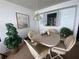 Dining room with table, chairs, and kitchen pass-through at 300 Woodette Dr # 203, Dunedin, FL 34698
