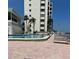 Another view of the community pool with lounge chairs at 300 Woodette Dr # 203, Dunedin, FL 34698