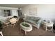Living room with sofa, coffee table, and dining set at 300 Woodette Dr # 203, Dunedin, FL 34698