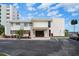 Community building exterior with parking lot at 300 Woodette Dr # 203, Dunedin, FL 34698