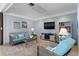 Relaxing common area with comfortable seating and a large TV at 300 Woodette Dr # 203, Dunedin, FL 34698