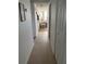 Long hallway leading to living area with tiled floor at 300 Woodette Dr # 203, Dunedin, FL 34698