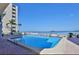 Inviting community pool with water view at 300 Woodette Dr # 203, Dunedin, FL 34698