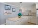 Well-equipped kitchen featuring white cabinetry and a large island at 300 Woodette Dr # 203, Dunedin, FL 34698