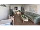 Living room features sofa, coffee table, and dining area at 300 Woodette Dr # 203, Dunedin, FL 34698