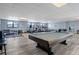 Well-equipped gym with cardio machines, weights, and a pool table at 300 Woodette Dr # 203, Dunedin, FL 34698
