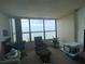 Living room with water view and relaxing armchair at 300 Woodette Dr # 203, Dunedin, FL 34698