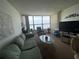 Living room with water view and comfy seating at 300 Woodette Dr # 203, Dunedin, FL 34698
