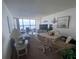 Spacious living room with water view and dining area at 300 Woodette Dr # 203, Dunedin, FL 34698