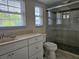 Bathroom with walk-in shower, single sink vanity, and toilet at 131 E Bay Dr, Treasure Island, FL 33706