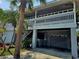 Two-story house with gray siding, balcony and attached garage at 131 E Bay Dr, Treasure Island, FL 33706