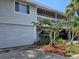Two-story house with gray siding, balcony and attached garage at 131 E Bay Dr, Treasure Island, FL 33706
