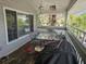 Covered porch with outdoor dining set and grill at 131 E Bay Dr, Treasure Island, FL 33706