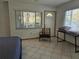 Bedroom with large window, tile floors, and access to porch at 131 E Bay Dr, Treasure Island, FL 33706