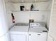 Laundry closet with washer and dryer, shelving and fire extinguisher at 131 E Bay Dr, Treasure Island, FL 33706