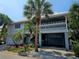 Two-story house with gray siding, balcony and attached garage at 131 E Bay Dr, Treasure Island, FL 33706